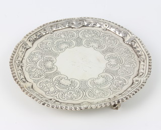 A George III silver card tray with simple chased decoration and armorial on claw and ball feet, London 1816, ,18cm, 276 grams 