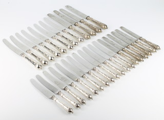 Twelve silver handled table knives and 18 do. dessert knives