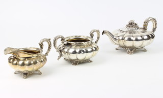 A William silver melon shaped teapot with scroll handle and floral finial together with a do cream jug London 1832 together with an ensuite sugar bowl London 1827, maker Joseph Angell I and Joseph Angell 11 1300 grams 
