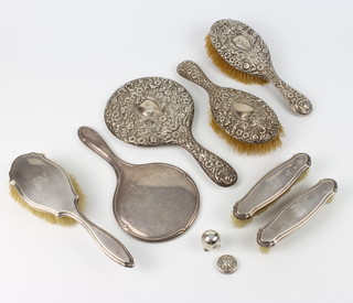 A 3 piece repousse silver brush and mirror set, a do., a lid and a pepper together with a hand mirror 