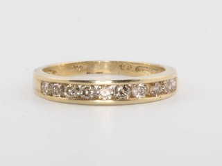 A 10ct yellow gold channel set diamond ring size N 