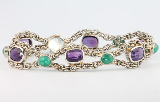 An 18ct white gold oval cut amethyst and emerald bracelet set with 6 amethysts and 6 emeralds, 18.5cm 