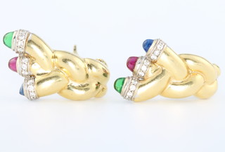 A pair of stylish 1970's 18ct yellow gold twist ear clips, each set with a cabochon cut emerald, a cabochon cut ruby and cabochon cut sapphire, the terminals surrounded by 10 brilliant cut diamonds, 26mm long, gross weight 23 grams 