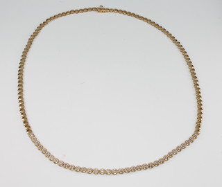 A 9ct yellow gold brilliant cut diamond set necklace comprising 34 diamonds, 43cm 