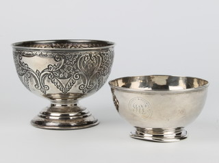An Edwardian repousse silver rose bowl with floral decoration Birmingham 1903 and a silver pedestal bowl 196 grams 