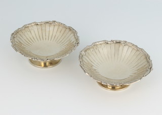 A pair of silver scalloped dishes with fancy borders Birmingham 1939, 84 grams 