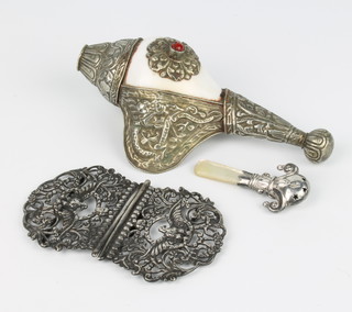 A Victorian cast silver buckle decorated with birds and flowers, a teething rattle and a mounted shell 