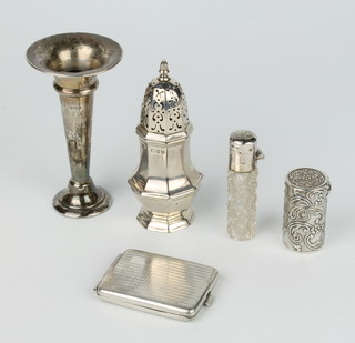 A Victorian silver octagonal pepperette, a lidded scent, a cylindrical box, spill vase and matchbook sleeve, 128 grams 