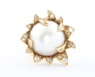 A stylish 1970's 18ct yellow gold pearl and diamond ring, the centre pearl 15mm surrounded by 25 brilliant cut diamonds 24mm wide, size I, gross weight 12 grams 