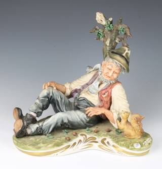 A Capodimonte group of a reclining tramp beside a tree with a squirrel signed Giaretto 28cm 