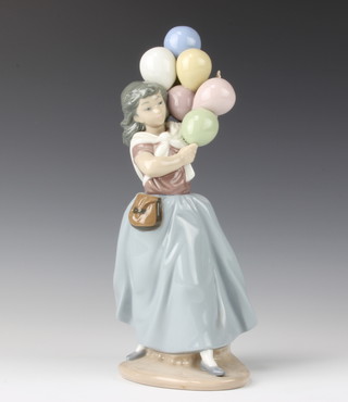 A Lladro figure of a female balloon seller 26cm  