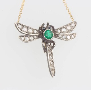 An Edwardian style emerald and diamond dragonfly pendant on a gold chain 