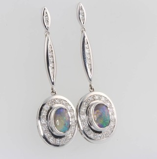 A pair of 18ct white gold opal and diamond drop earrings 