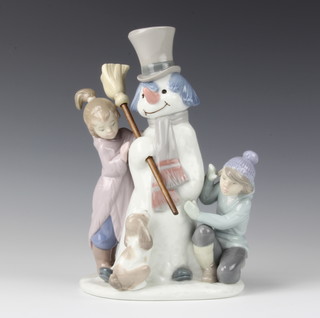 A Lladro group of a snowman, 2 children and a puppy 5713 20.5cm 