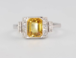 An 18ct white gold yellow sapphire and diamond ring, the centre stone approx. 1.8ct flanked by brilliant cut diamonds approx. 0.25ct size N 