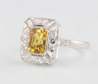 An 18ct white gold yellow sapphire and diamond rectangular cluster ring, the centre stone approx. 1.8ct surrounded by brilliant and baguette cut diamonds approx. 0.25 ct, size O 