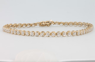 A 9ct yellow gold brilliant cut diamond set bracelet comprising 51 diamonds, 18.5cm