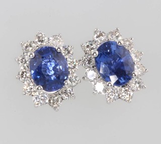 A pair of 18ct white gold oval sapphire and diamond ear studs, the sapphires 2.98ct, the diamonds 1.02