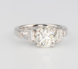 An 18ct white gold diamond ring, the centre stone approx. 1.89ct flanked by baguette and tapered baguette diamonds size K, colour J, clarity SI1 with EDR certificate 