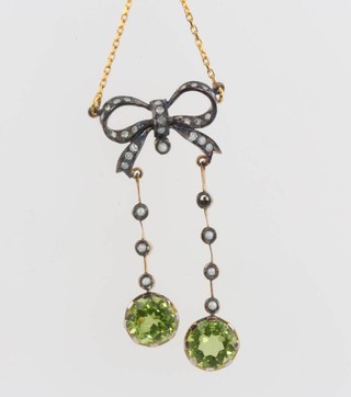 A yellow gold peridot and seed pearl pendant on a gold chain 
