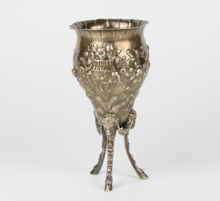 A 19th Century continental repousse silver tapered cup decorated with flowers raised on a trefoil base with rams heads and hoof feet, Import marks Sheffield 1894, 16cm 