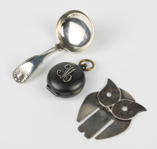 A Victorian gun metal sovereign case, a silver caddy spoon and a bookmark in the form of an owl 