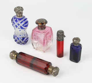 A Victorian ruby glass silver mounted scent 7cm, a blue glass do. 6cm, a flash blue glass waisted do. 10cm, a cranberry do. with pique jour lid 7cm and a double ended ruby do. 12cm 