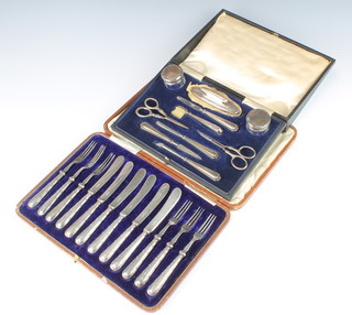 A silver mounted ten piece manicure set cased a cased set of dessert eaters for 6 