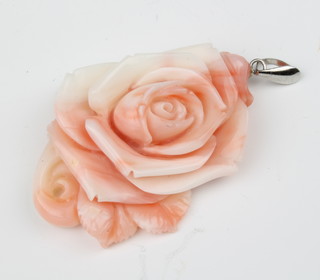 A carved coral floral pendant