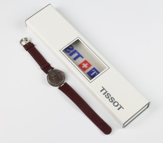 A gentlemans Tissot rock watch on a burgundy strap boxed