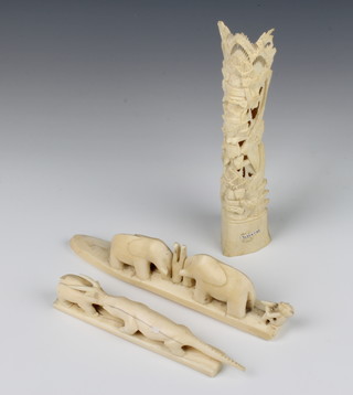 A carved ivory group of two elephants and a hunter 21cm, a do. of an alligator 17cm, a carved bone figure 20cm 