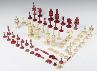A quantity of 19th Century turned and stained bone chess pieces 