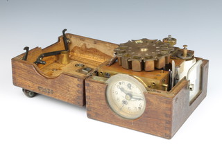 A German pigeon racing clock contained in an oak case 