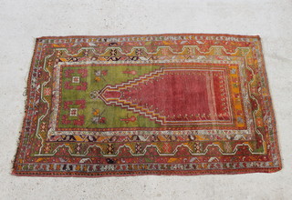 A Turkish green and tan ground prayer rug 184cm x 123cm 
