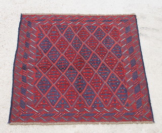 A blue and red ground Gazak rug with diamond decoration 115cm x 124cm 