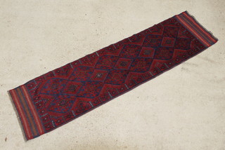A blue and red ground Meshwani runner with 17 diamonds to the centre 260cm x 67cm 
