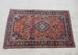 A red and blue ground Kashan rug with central medallion within multi row borders 195cm x 128cm