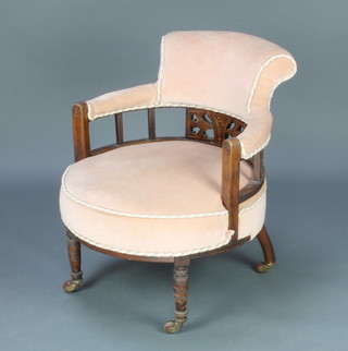 An Edwardian inlaid mahogany tub back chair, the seat and back upholstered in peach coloured Dralon, raised on turned supports  