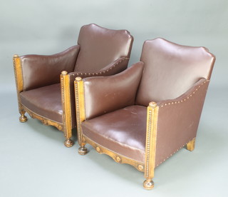 A pair of 1930's Art Deco oak show frame armchairs upholstered in brown rexine 