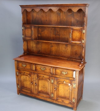A 17th/18th Century style oak dresser, the raised back with cornice and fitted 2 shelves and a  a pair of small cupboards, the base fitted 3 long drawers above a triple cupboard, raised on square supports 183cm  h x 137cm w x 46cm d  
