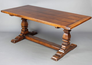 A 17th Century style oak refectory dining table, the top formed of 4 planks raised on square shaped supports with X framed stretcher complete with extension 76cm h x  91cm w x 182cm l and with extension 232cm l