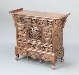 A Chinese pierced and carved hardwood table top cabinet fitted 2 cupboards above 2 long drawers, raised on cabriole supports 61cm h x 68cm w x 29cm d 