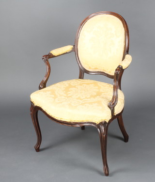 An Edwardian show frame mahogany salon chair with upholstered seat and back, the seat of serpentine outline and raised on cabriole supports 
