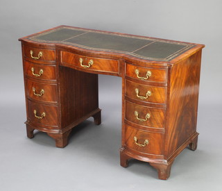 A Georgian style mahogany pedestal desk of serpentine outline with inset tooled leather writing surface above 1 long and 8 short drawers, raised on bracket feet 75cm h x 115cm w x 53cm d (in one section) 