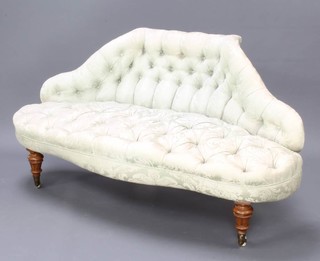 A Victorian salon salon style shaped sofa, upholstered in pale green buttoned back material, raised on turned and fluted walnut supports  79cm h x 148cm w x 70cm d 
