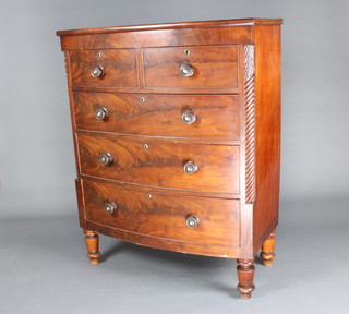 A Victorian mahogany bow front chest of 2 short and 3 long drawers with tore handles and column decoration to the sides, raised on turned supports 130cm h x 102cm w x 50cm d 