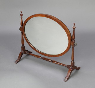 A Georgian style oval plate dressing table mirror contained in a mahogany swing frame 46cm h x 50cm w x 23cm d 
