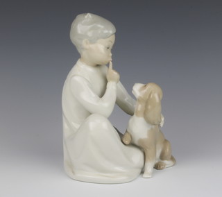 A Lladro figure of a seated child and puppy 19cm 

