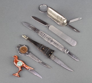 Six novelty knives comprising a John Watts knife with the King and Queen's accession dates to the grip 1066-1910, a puzzle knife, a pocket knife the grip in the form of the Eiffel Tower, a lighter knife and a Lebanese knife in the form of a bird  