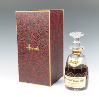 Grande Fine Champagne Cognac over 50 years old, contained in a Stuart cut glass mallet shaped decanter, specially selected and shipped for Harrods of Knightsbridge (some evaporation) 